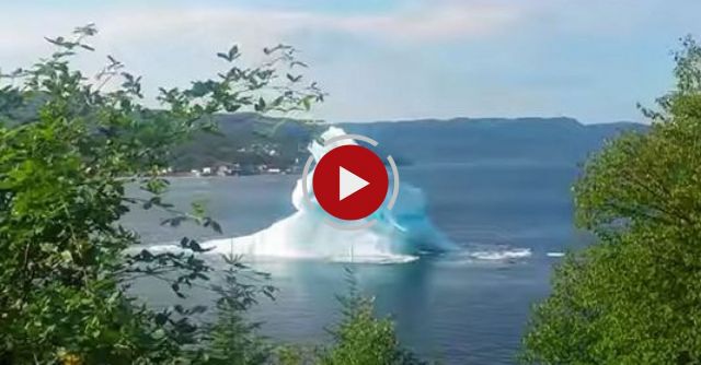 Iceberg Rolling Over And Breaking