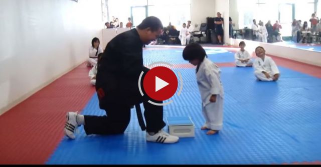 Little Boy Trying To Break Board In Taekwondo