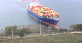 Container Ship Sails Straight To Shore By University Football Field