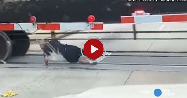 Man Rolls Under Moving Train