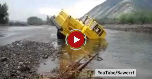 A Russian Tractor Driver Refuses To Give Up After His Vehicle Gets Stuck In A River.