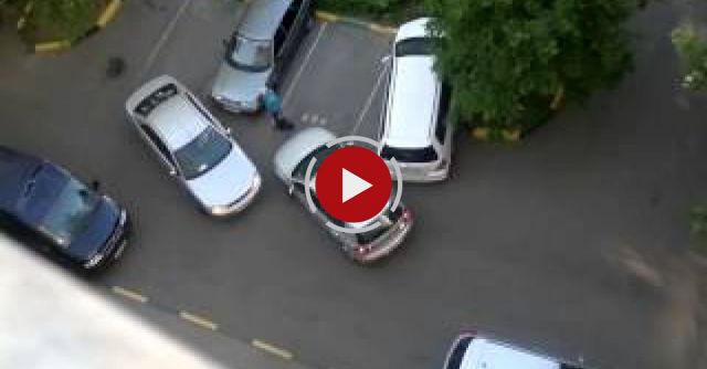 Two Women Struggle In A Parking Lot