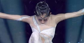 Dancer begins by squatting on stage, and her moves leave the crowd on their feet