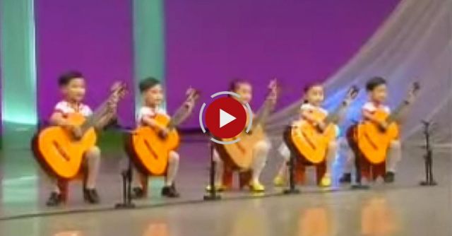 North Korea Children Playing The Guitar. Creepy As Hell.