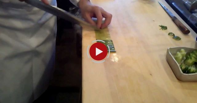 Sushi Chef Demonstrating Cucumber Slicing Techniques