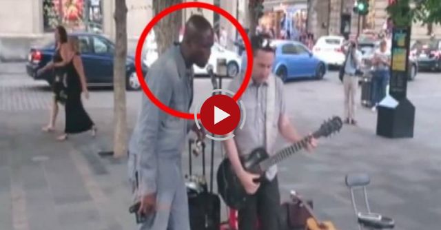 A street performer plays 'Stand By Me' - An international star joins him