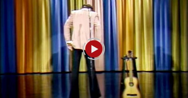 He starts onstage with his back to the crowd, when he turns around they erupt 