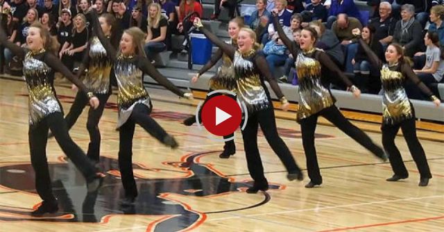 High school dancers keep going with their routine after the music cuts out