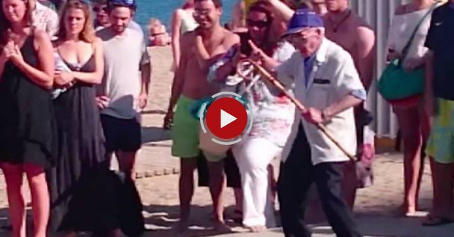 This elderly fan of a street performer busts a move in style